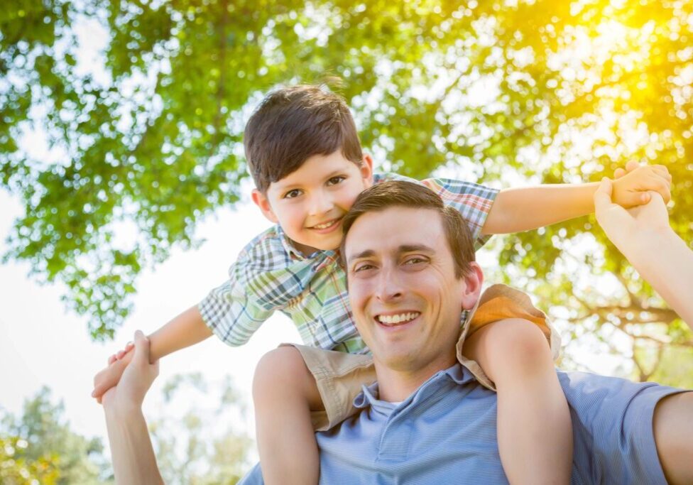 A man and boy are smiling for the camera.